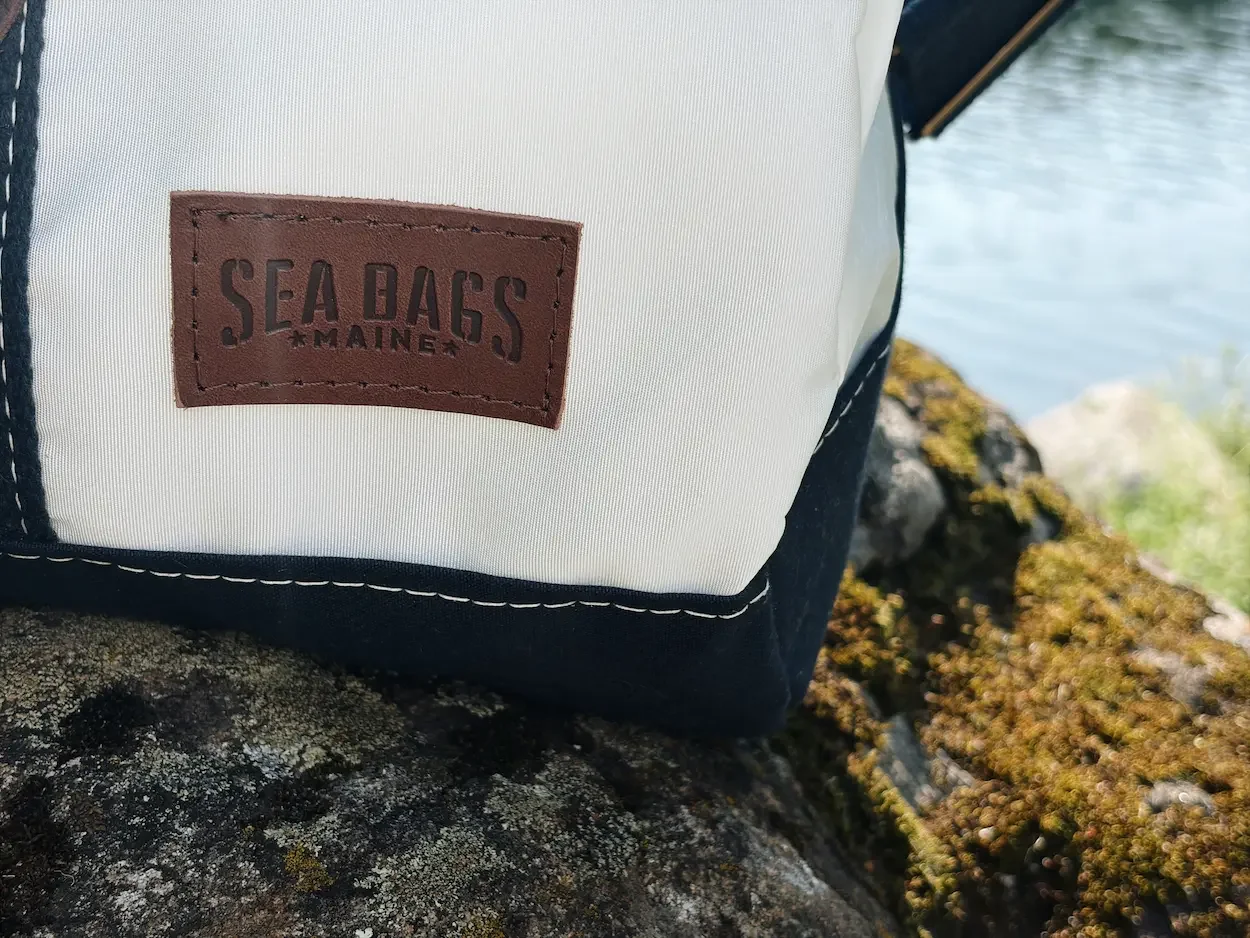 Sea Bags Maine leather logo patch stitched onto white reclaimed sailcloth
