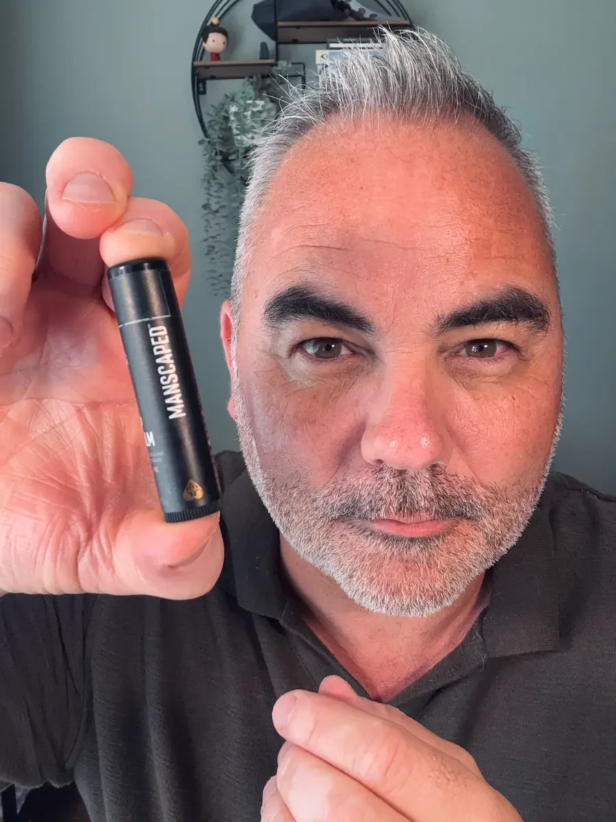 Manscaped Lip Balm held close to the camera during a skincare review