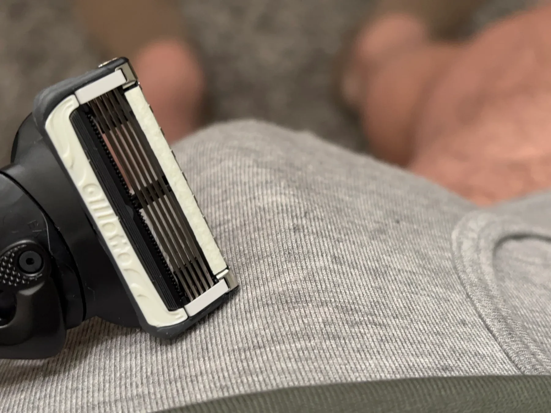 Close-up of the Gillette Intimate Razor held near grey boxer shorts to demonstrate its use for pubic hair and balls.