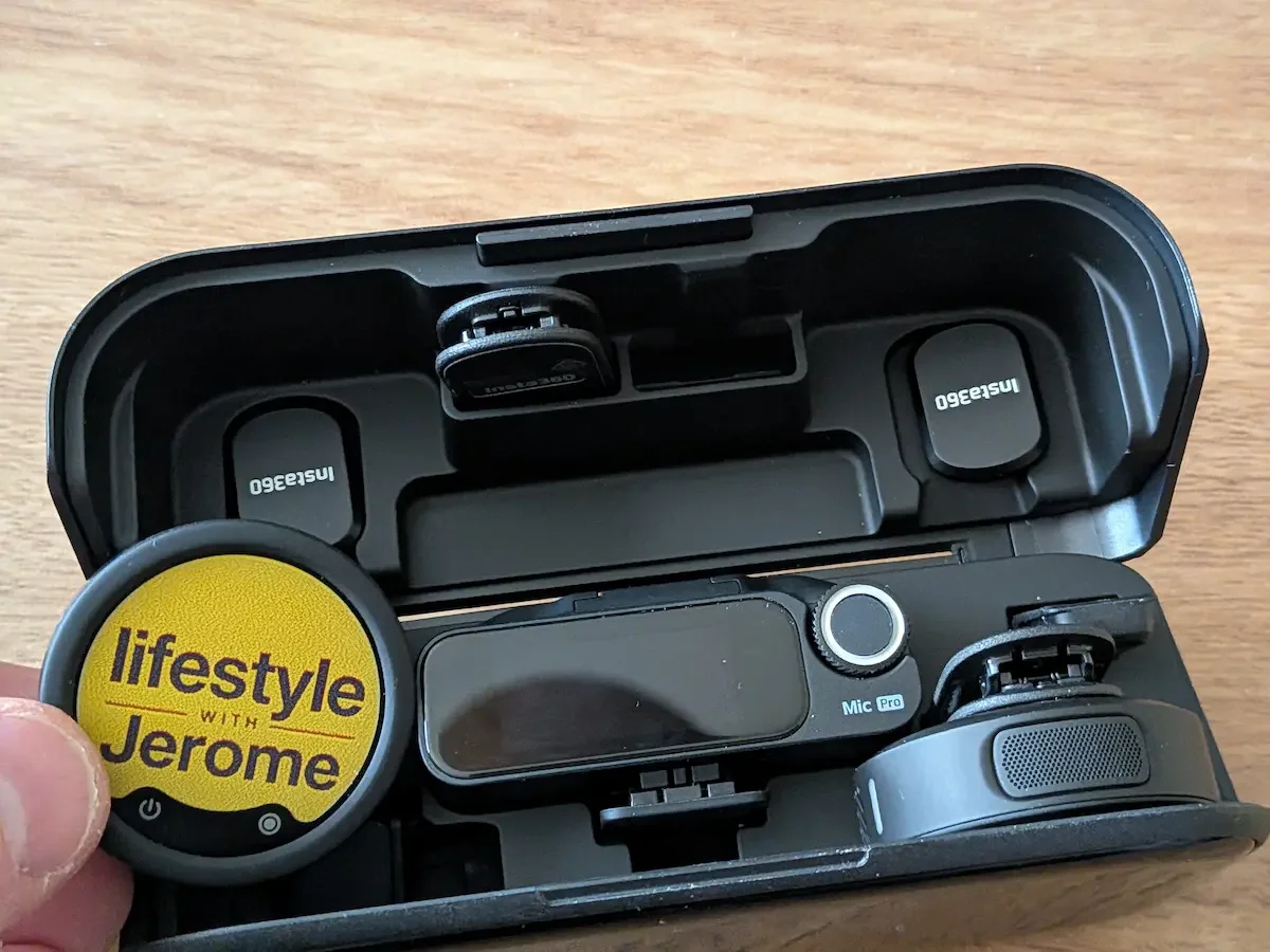 Insta360 Mic Pro charging case open with transmitter, receiver and personalised E-Ink display inside.