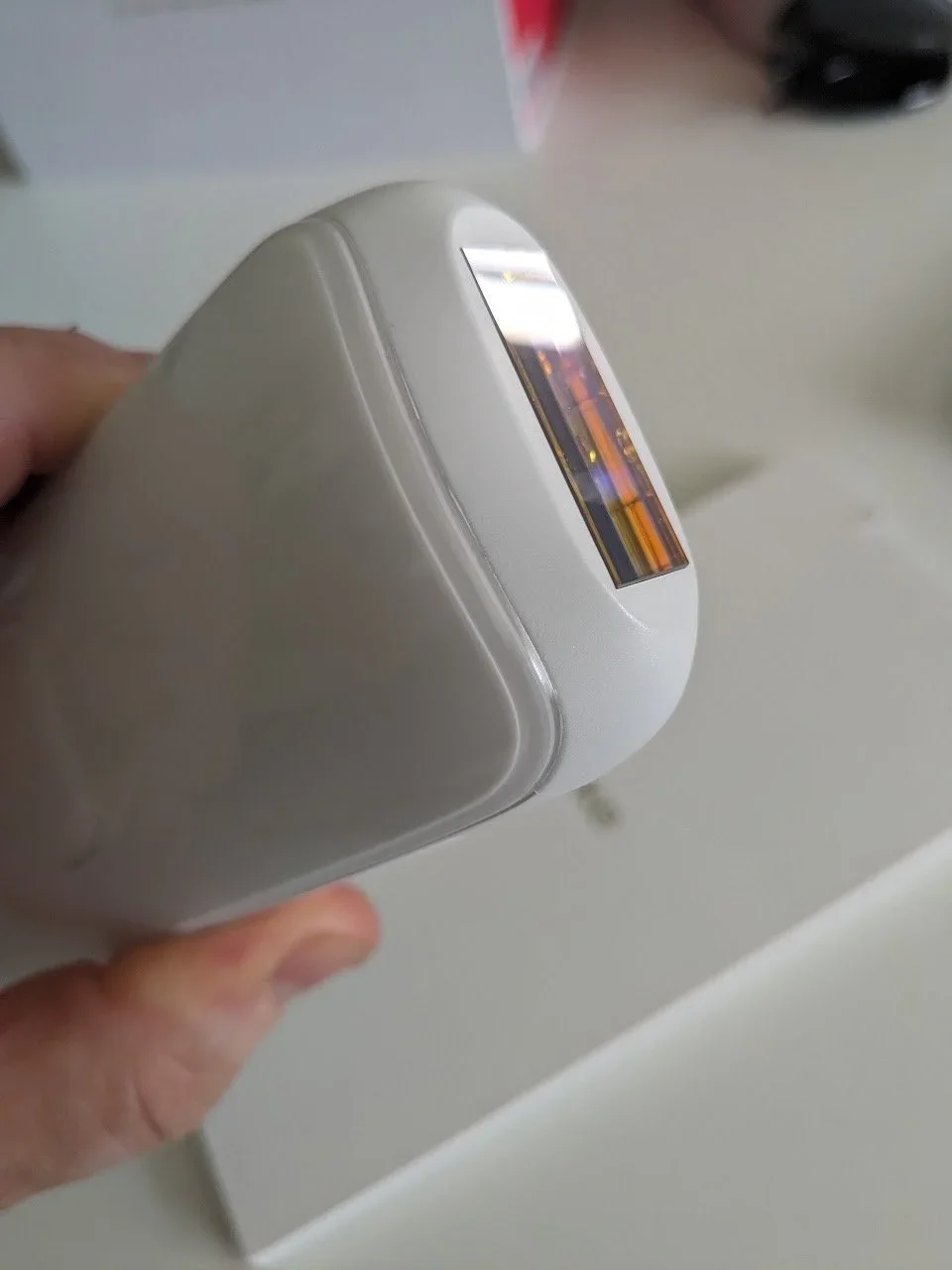 Close-up of the white Ulike Air 3 IPL hair removal device showing the sapphire treatment window.