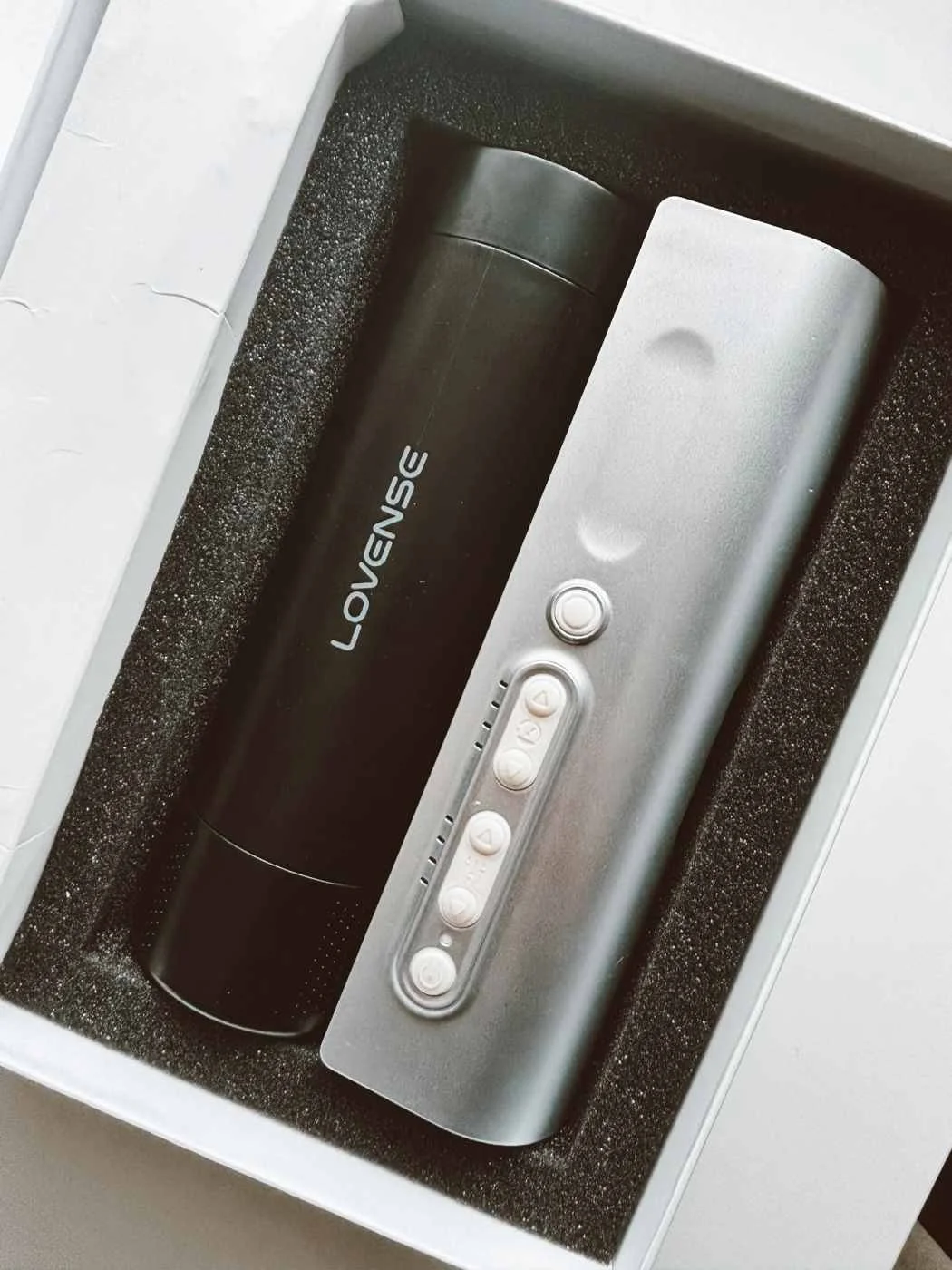 Lovense Solace Pro automatic male masturbator displayed in its box with controller and sleeve