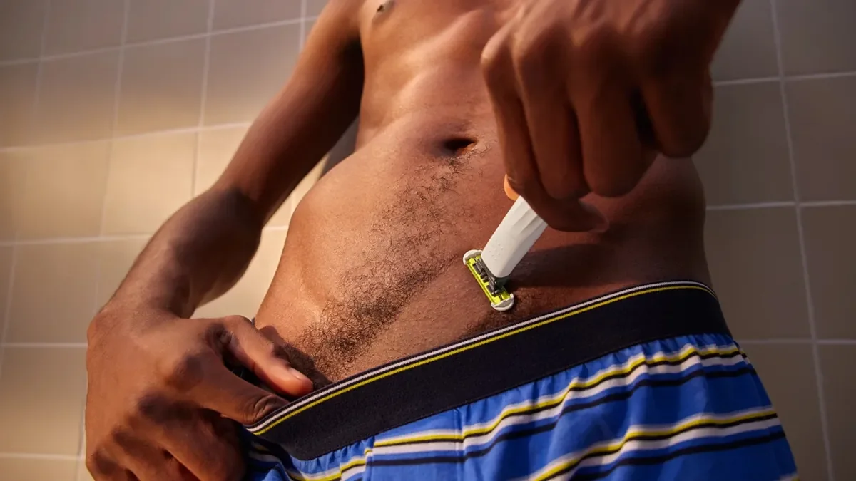 Man trimming body hair with an electric ball trimmer – best ball trimmers for men guide