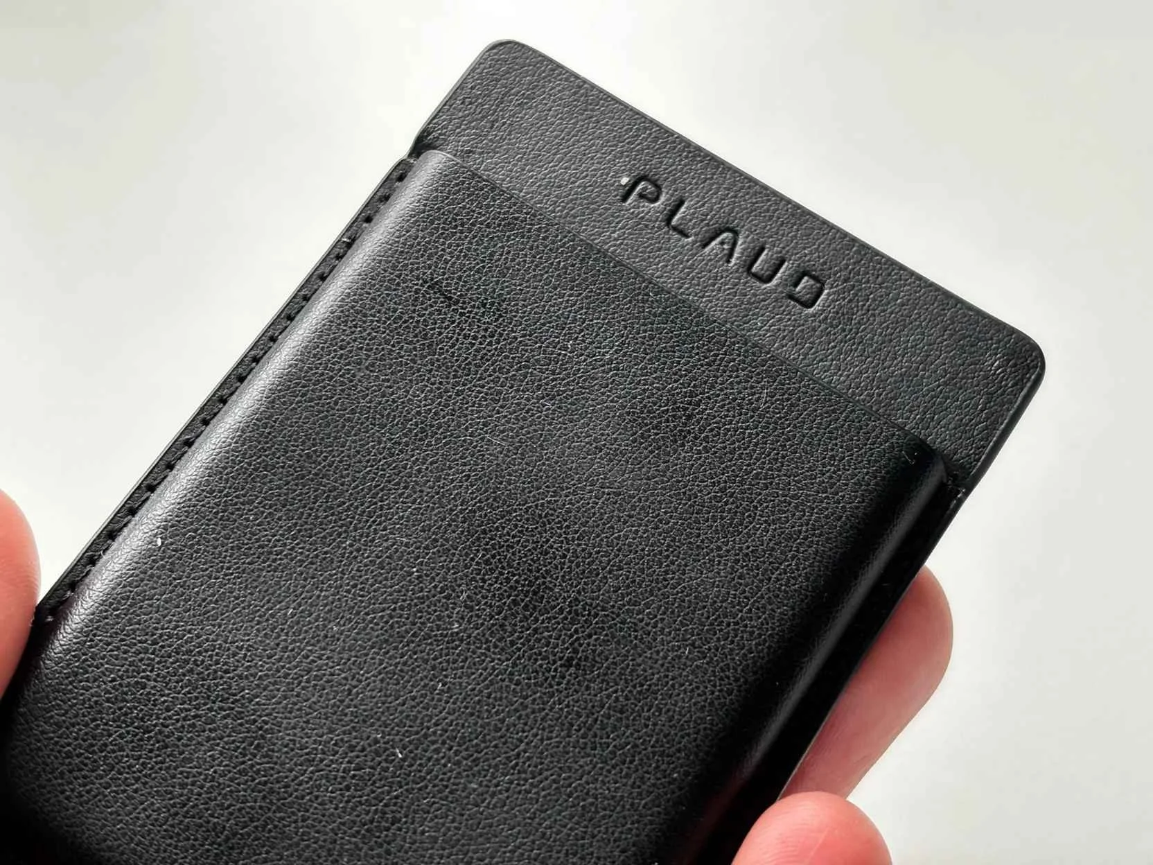 Close-up of the Plaud Note magnetic leather-style case showing the textured finish and branding
