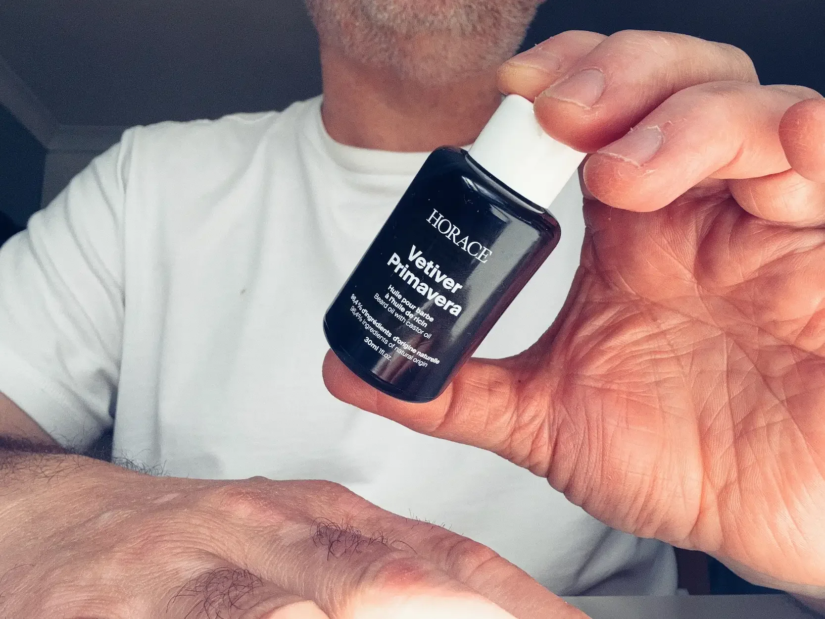 Jerome holding a bottle of Horace Vetiver Primavera beard oil