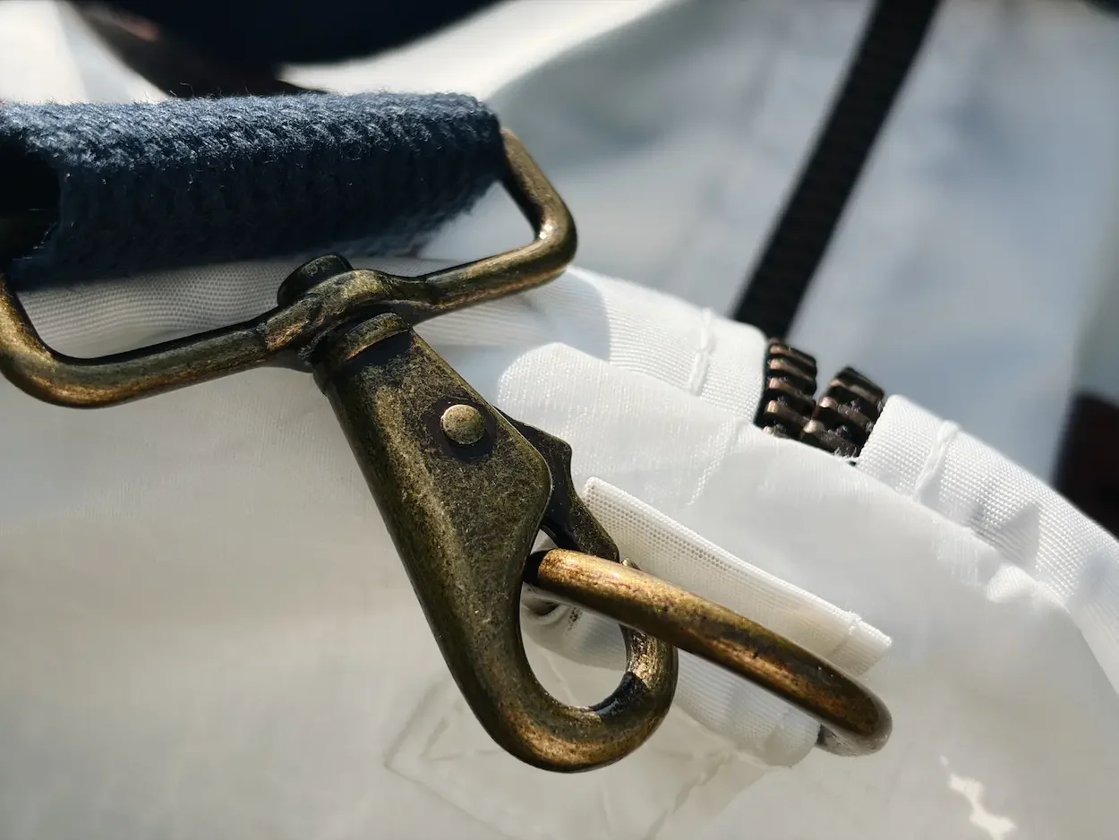 Close-up of the brass-tone shoulder strap clip and metal ring on the Sea Bags duffel
