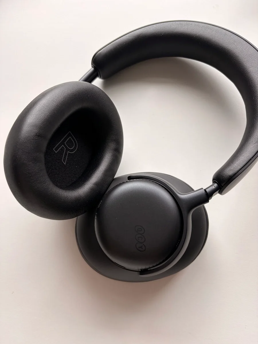 QCY H6 Ultra over-ear headphones in black showing the padded headband and large cushioned ear cups.