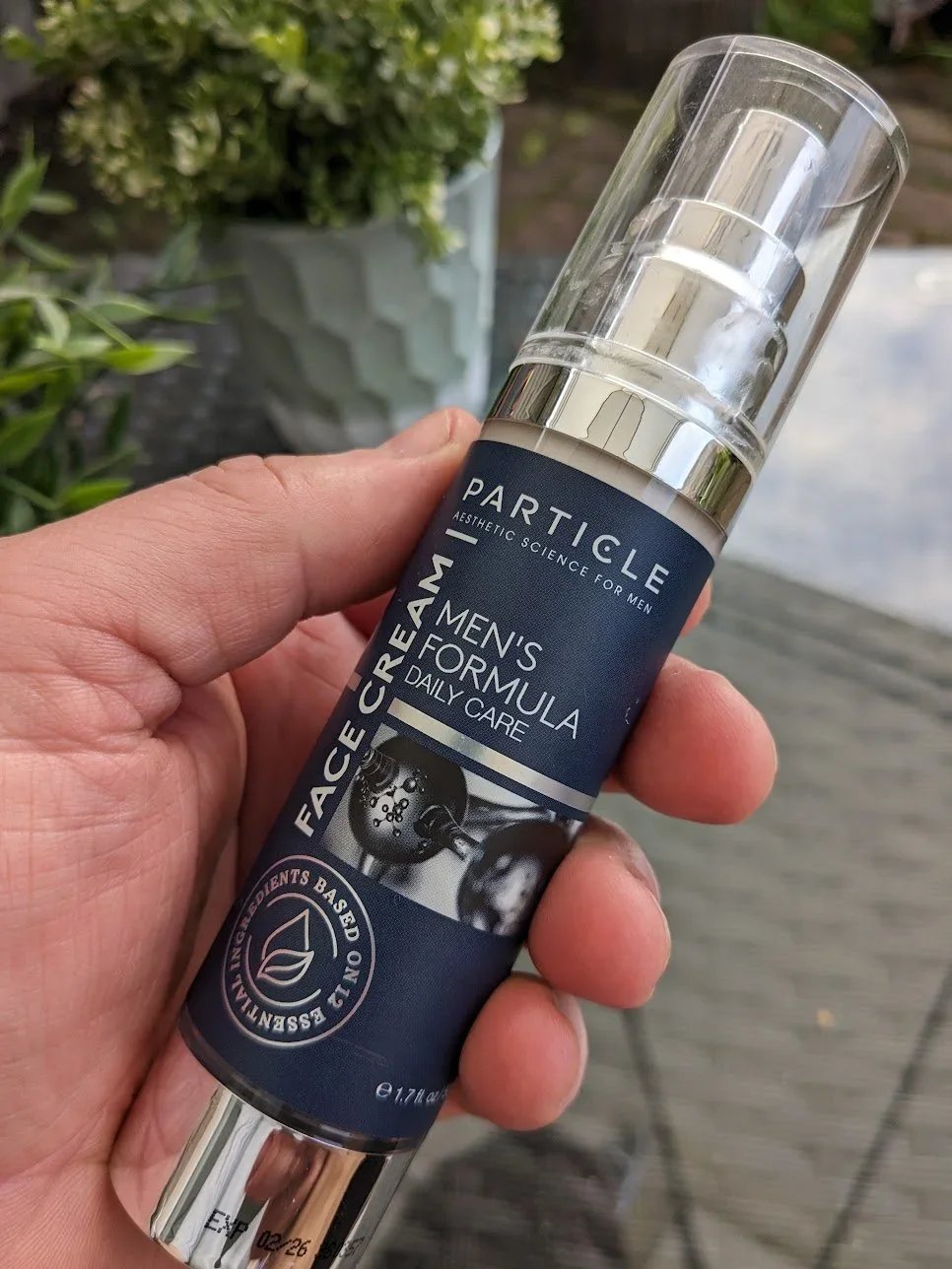 Particle Face Cream for men held outdoors — 6-in-1 daily face cream tested by Jerome at Dapper and Groomed