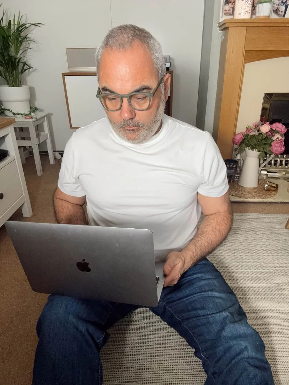 Sitting on the floor wearing the Bluffworks Departure Jeans to show comfort and versatility