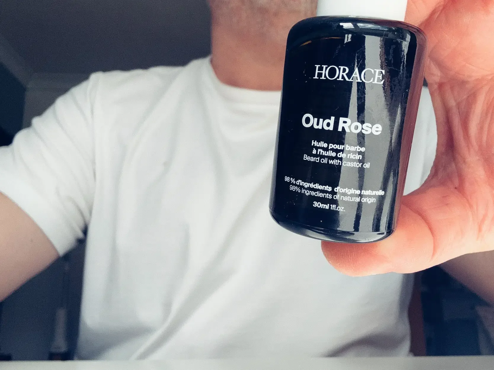 Jerome holding a bottle of Horace Oud Rose beard oil