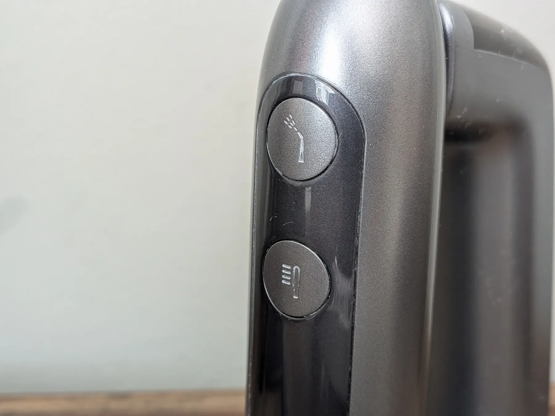 Close-up of the MarchPower 3-in-1 electric toothbrush control buttons for brushing and water flossing modes.