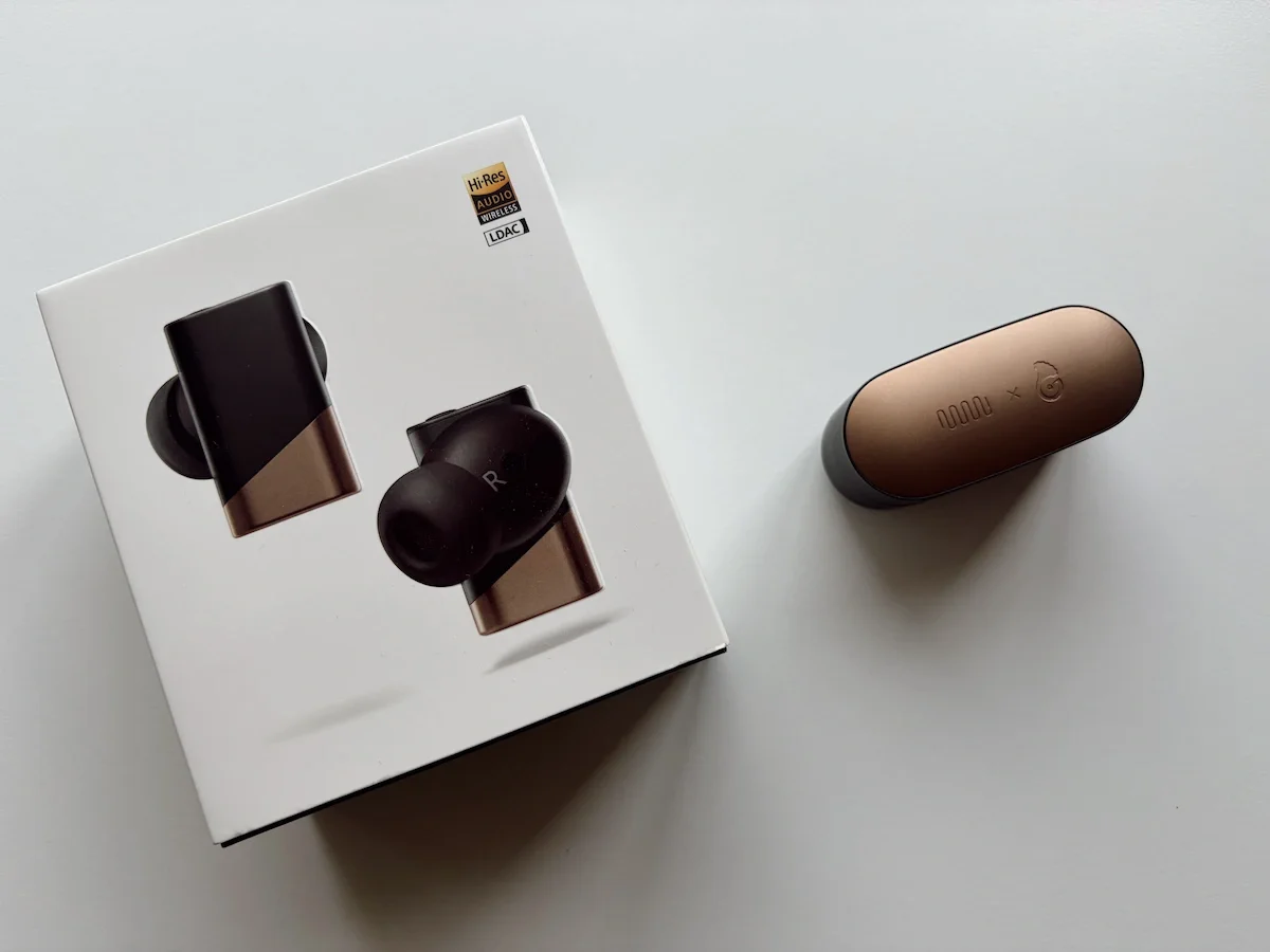 Status Audio GoldenSound Pro X retail box alongside the black and gold charging case