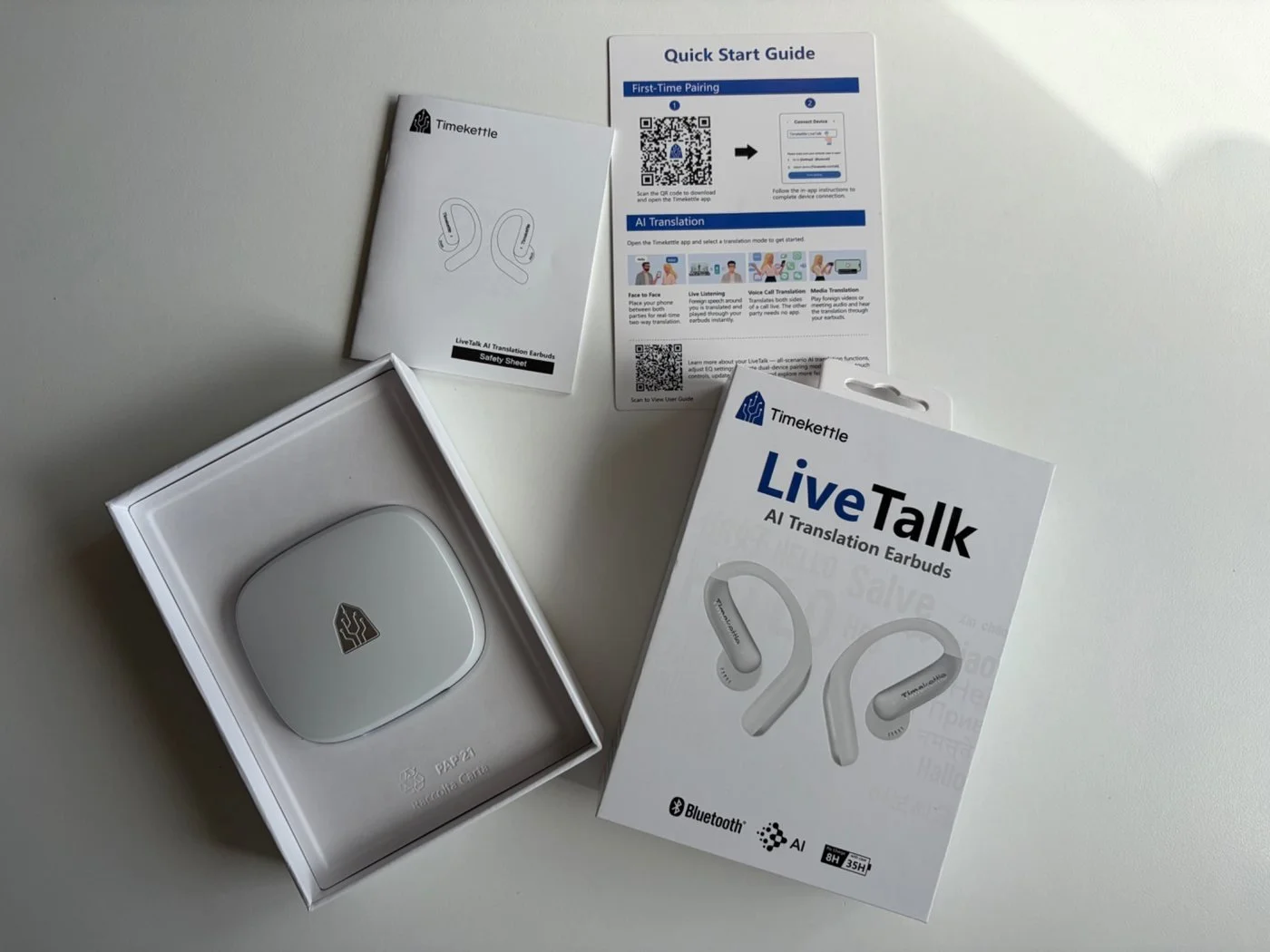 Timekettle LiveTalk AI Translation Earbuds packaging with the white charging case, quick start guide and safety instructions.