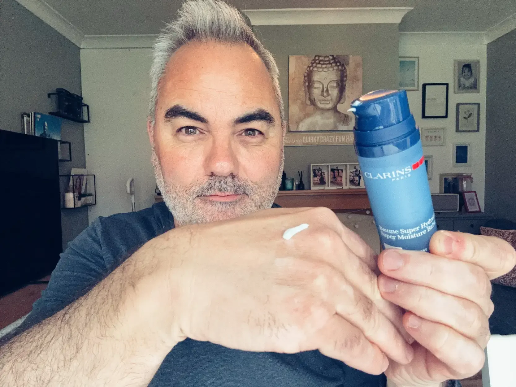 Jerome holding Clarins Men Super Moisture Balm with a small amount on his hand — lightweight face cream for men tested at Dapper and Groomed