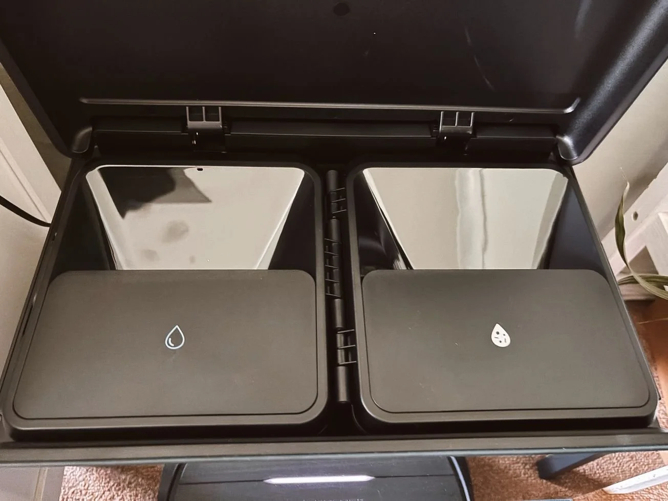 Roborock Saros 10 dock showing clean and dirty water reservoirs open