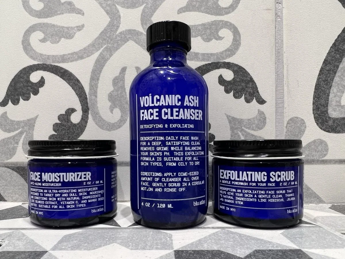 Blu Atlas Volcanic Ash Face Cleanser with Face Moisturizer and Exfoliating Scrub jars on a tiled surface