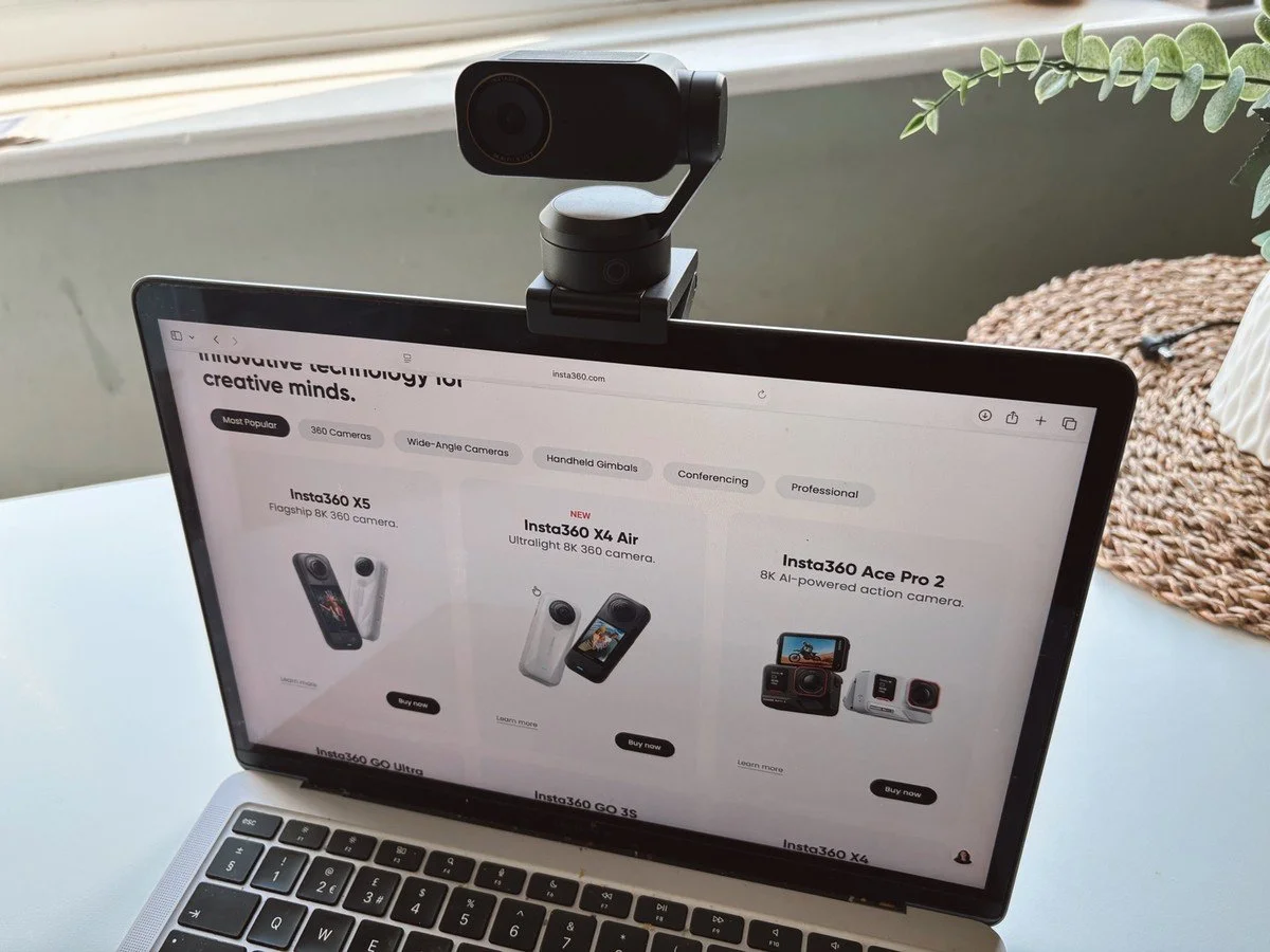 Insta360 Link 2 Pro AI webcam mounted on laptop showing Insta360 website