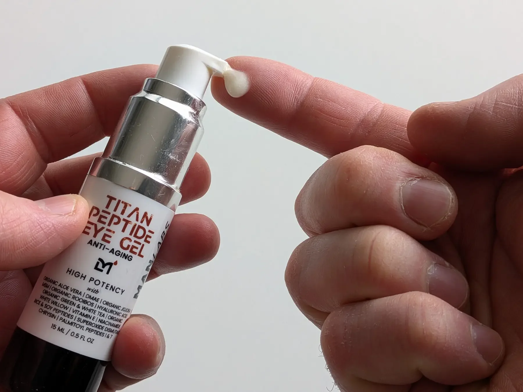 Close up of Man Labs Titan Peptide Anti-Aging Eye Gel texture on a finger to show consistency.