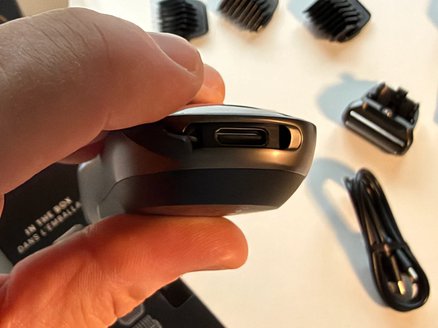 USB-C charging port on the base of the Manscaped Lawn Mower Ultra Gen 6, with its cover open.