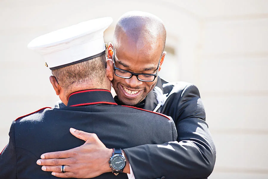 a - hotel monaco - 22 groom hugging father.jpg
