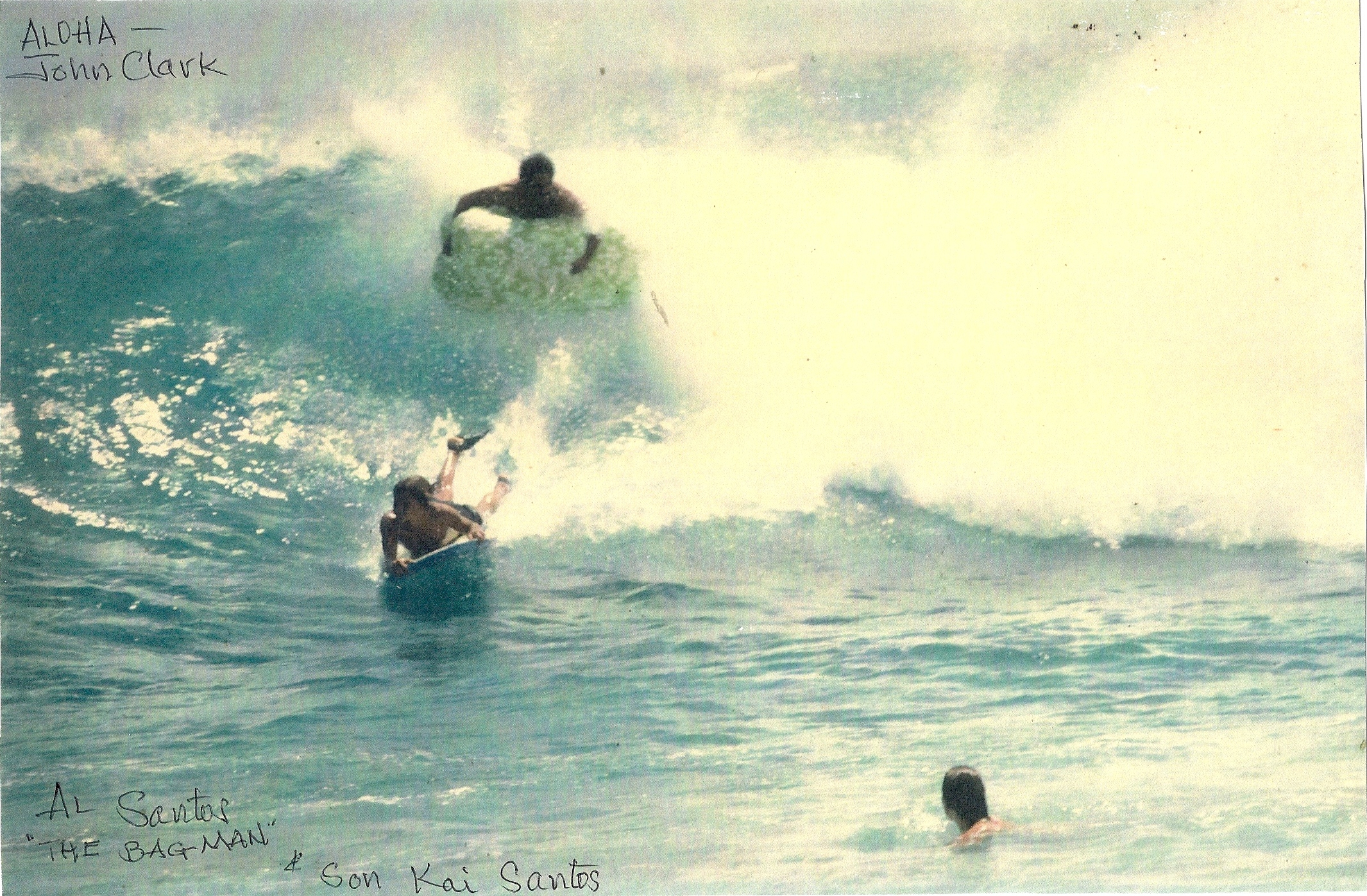 Al Santos surfing with his son Kai Santos on the bodyboard. Sandy Beach, Oahu. 1968