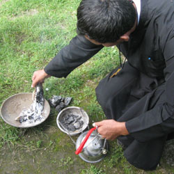 Fr. Blas (one of the native priests) prepares charcoal to put into a censer. The communities face a significant lack of quality liturgical items.