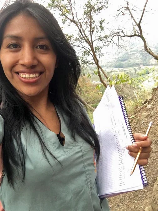 Juanita, taking census results in a small village as part of a public health practicum at her university
