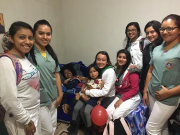 Juanita enjoys a visit with fellow classmates from her medical school