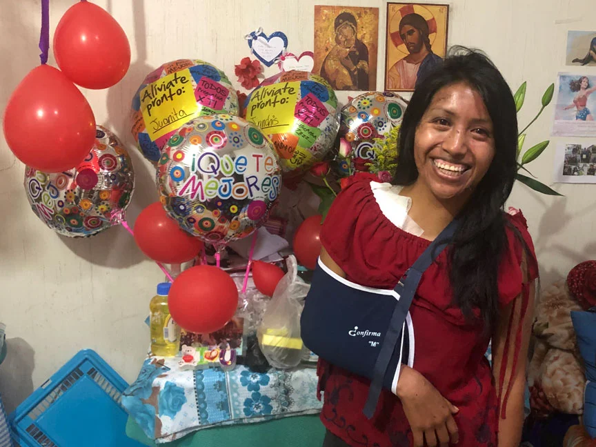 Juanita stands in front of gifts of encouragement from friends and family