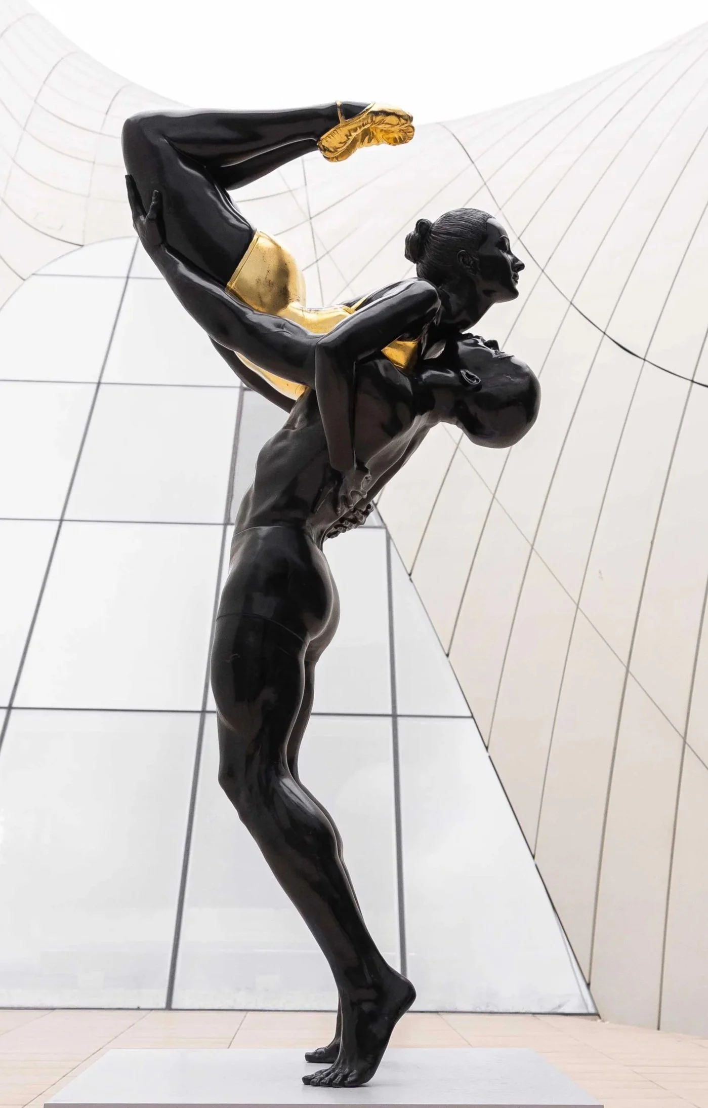 Strength

 

 2017 | 144 x 48 x 48 in (366 x 122 x 122 cm) | Patinated Bronze with Gold Leaf Accents | Heydar Aliyev Center, Baku, AZ 