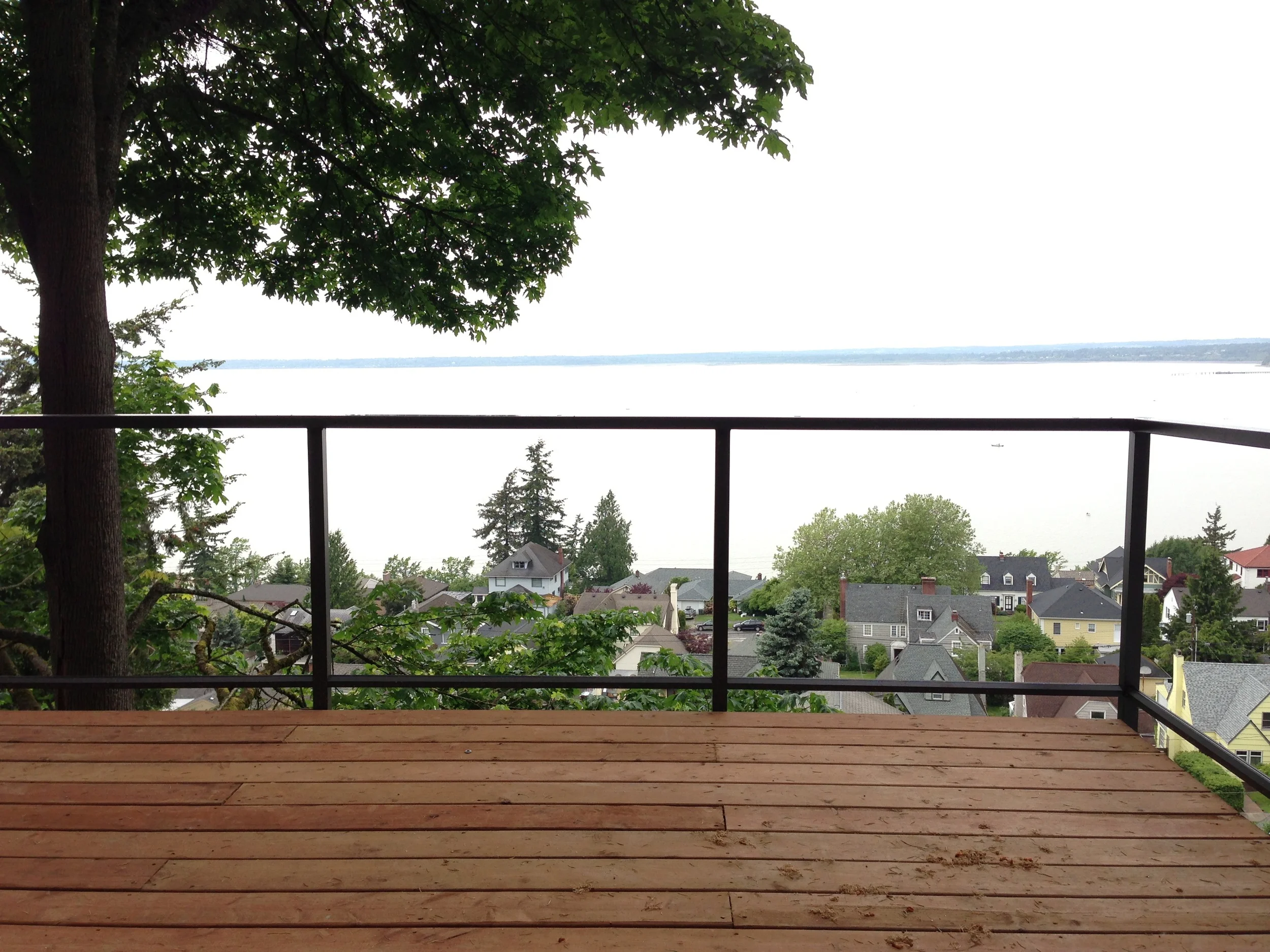 Powder coated aluminum railing (with tempered glass--not installed yet in the photo). The color we chose was called Rideau Brown.