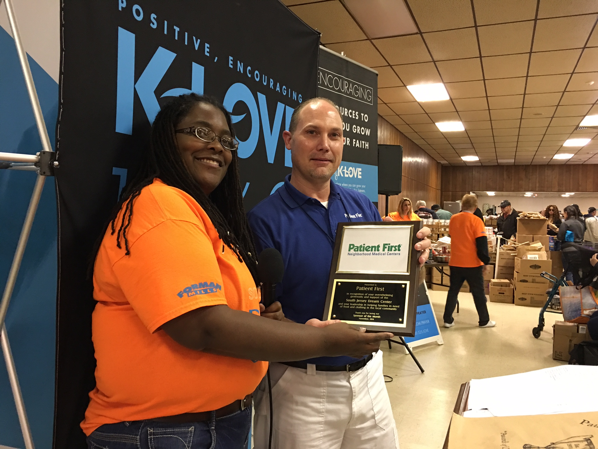 Hilari Luck, of the South Jersey Dream Center Executive Team presents Tom Murtaugh, RN Director of Medical Support, with Sponsor of the Month plaque on behalf of Patient First in Woodbury.