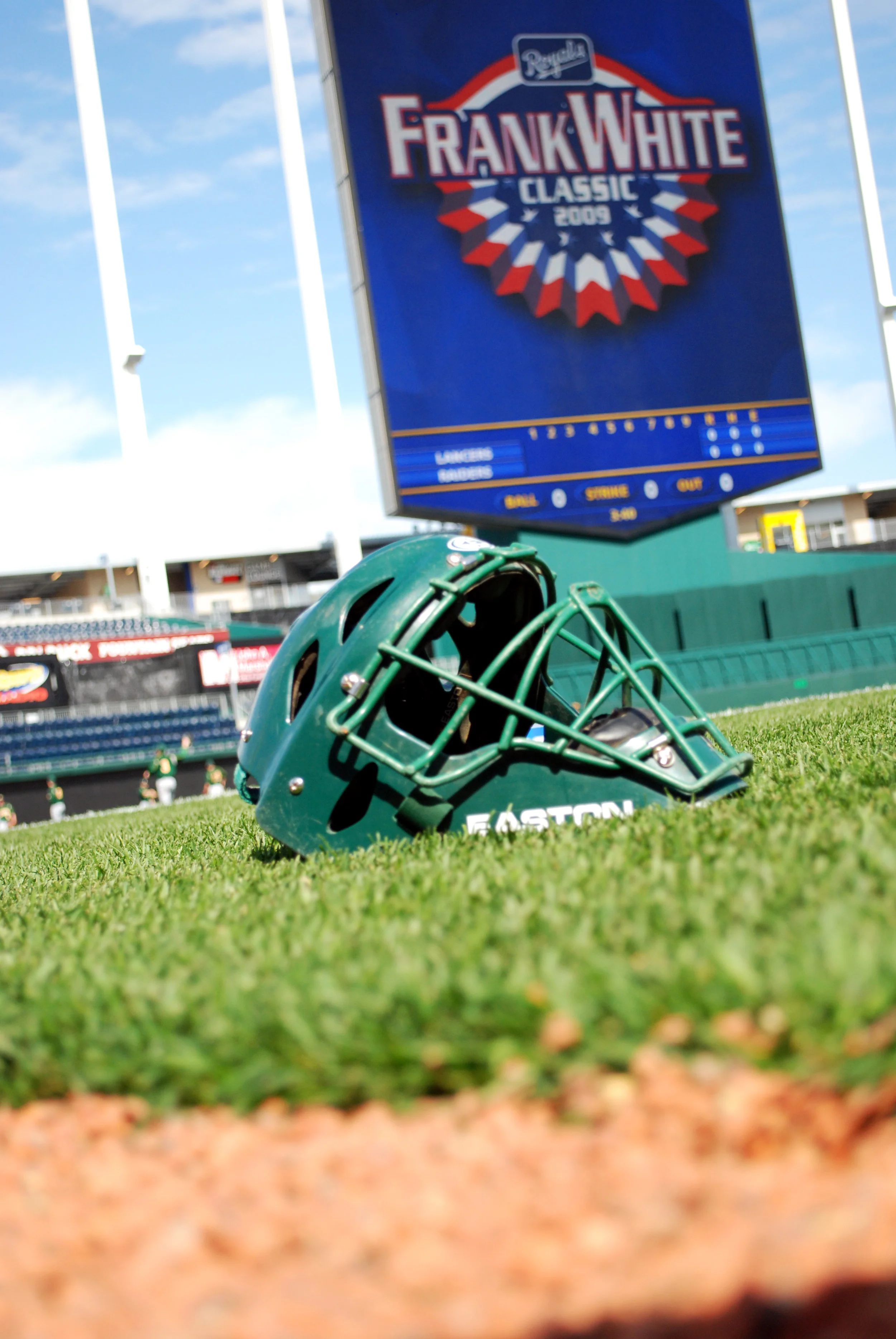 Baseball catchers helmet on baseball field.