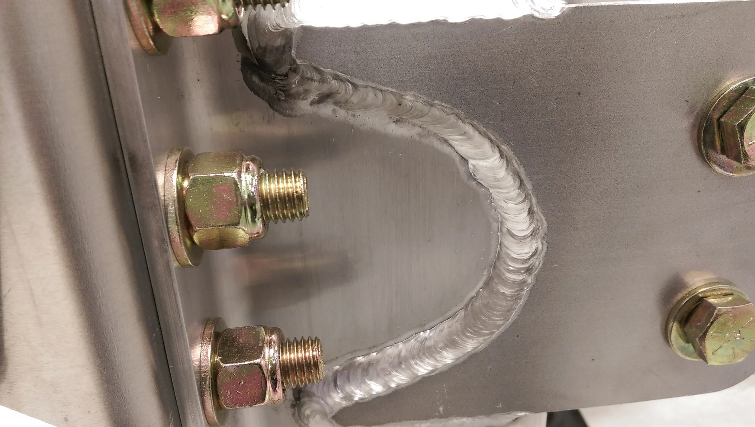 A manual weld on a large arc between 3/8` and 1/8`aluminum plate. This is a great example of a solid manual aluminum weld using Fronius welding equipment. This weld is challenging because the employee has to re-position themselves several times to make sure the correct torch angle is achieved as they move around the arc to ensure the shielding gas is protecting the leading edge of the weld pool.