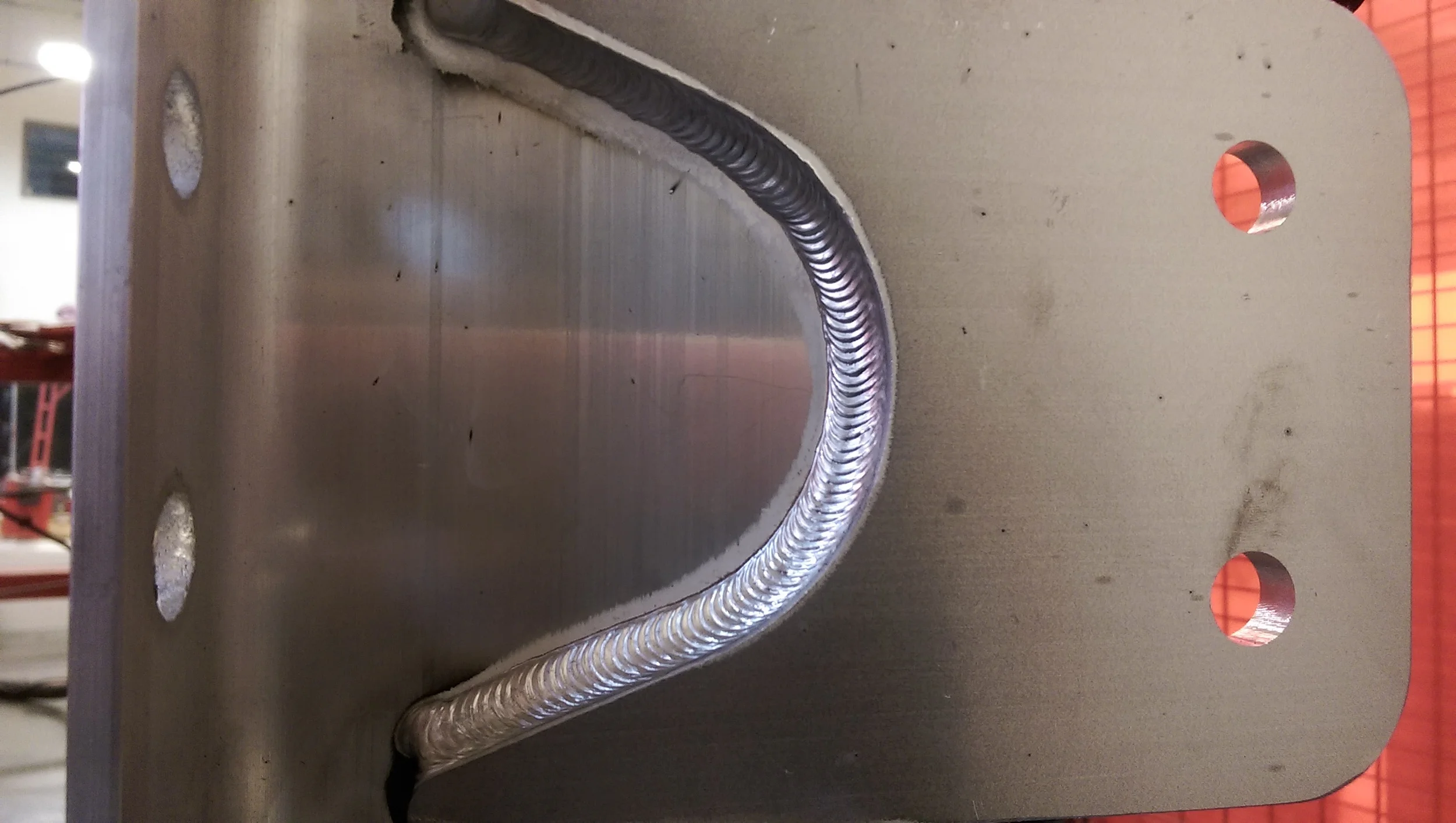 Here is the after picture of the same parts welded together but using an automated robotic welding cell. The weld has a bit more shine to it mostly due to the perfect torch angle being achieved by the robot`s perfect welding program made directly out of our CAD models. The weld bead size is also perfect every time. 