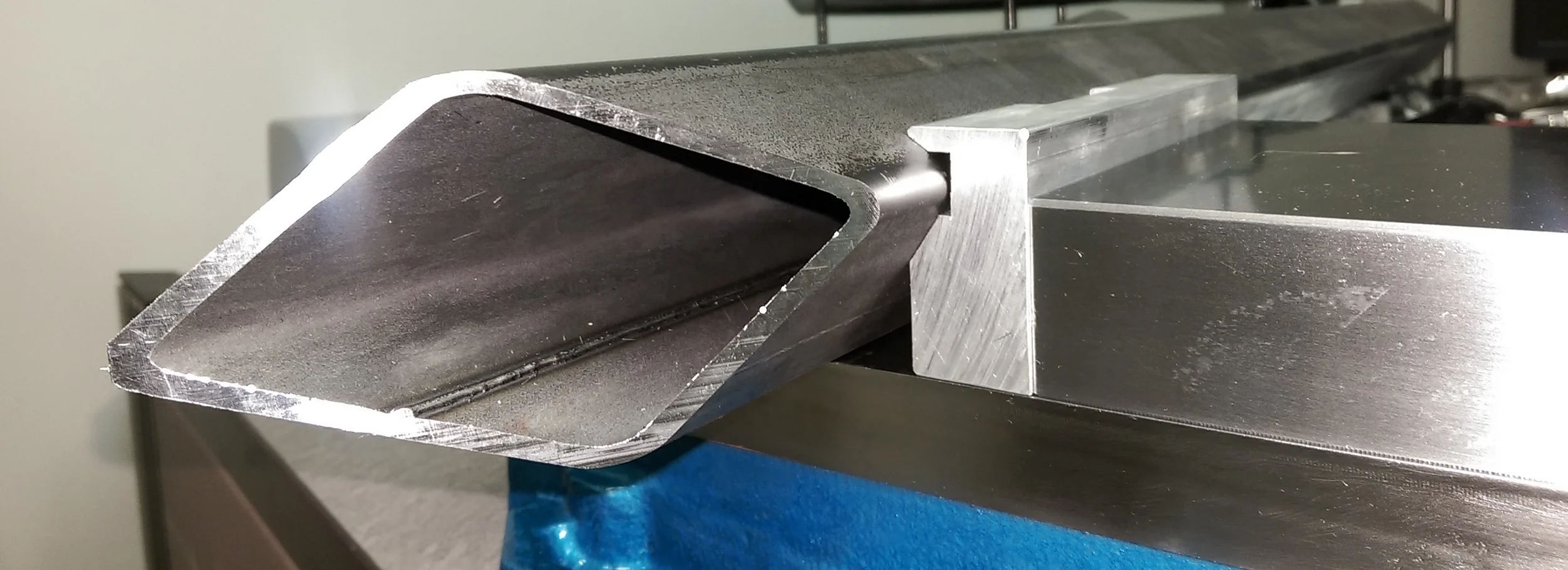 Here is the finished tube mounted in the vise to show how it turns it on the exact angle so the operation can be completed from just one top cutting plane.