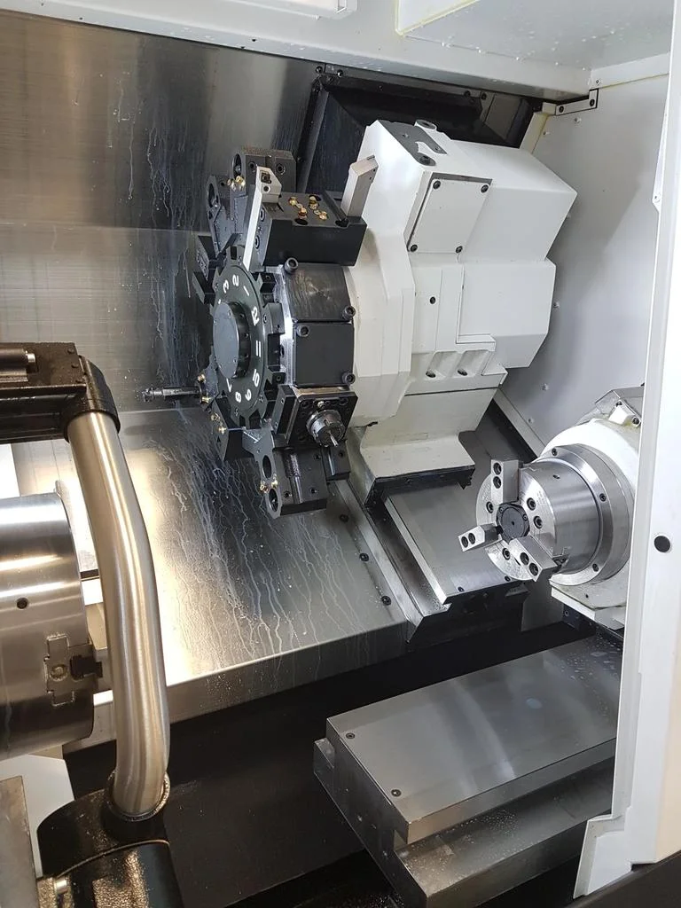 Here is a view inside the machine. On the left is the main 10" spindle, center is the tool turret, and the right is a 7" sub-spindle.