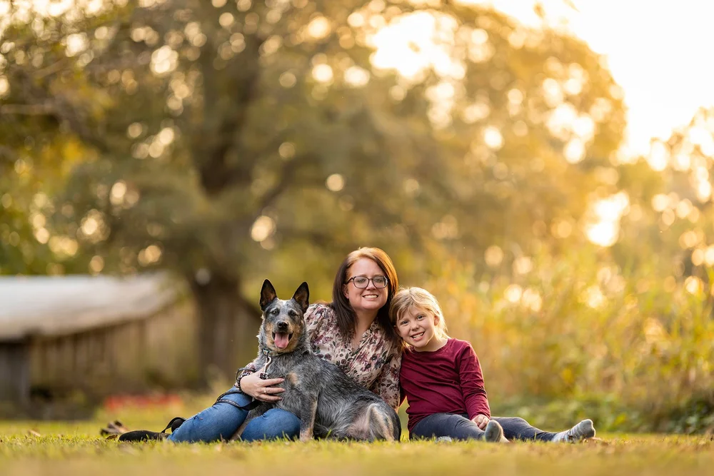 Mother and child with their dog in golden light
