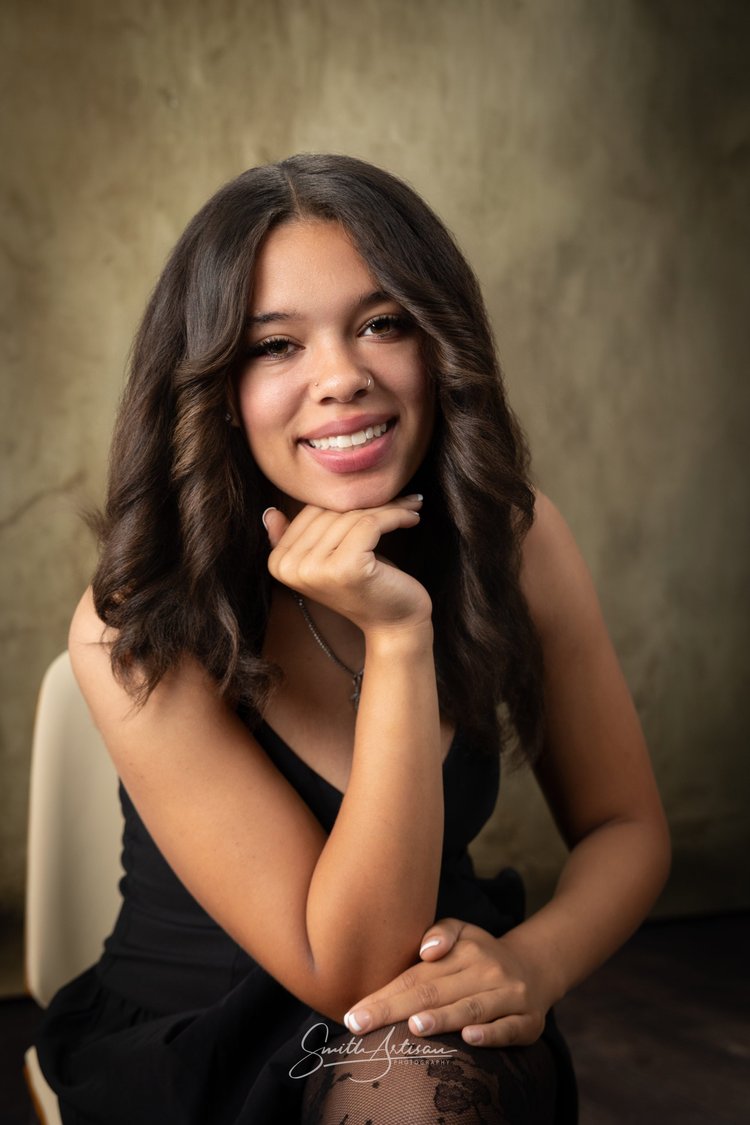 Senior yearbook portrait seated in a studio setting