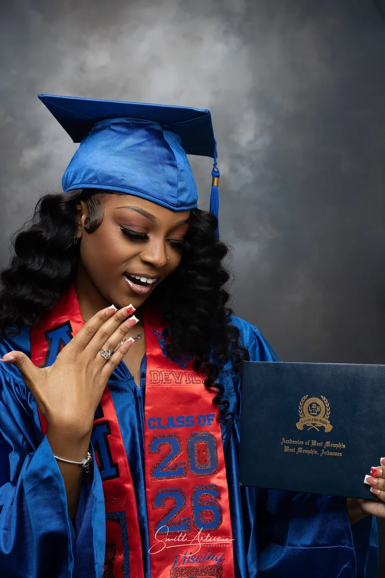 Senior yearbook portrait in cap and gown holding diploma