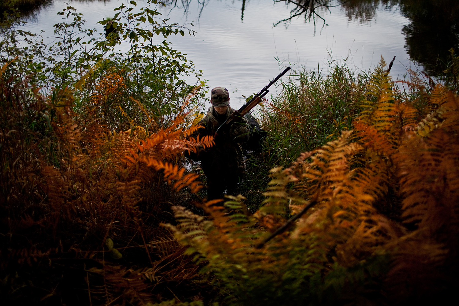  Isaac Eisch climbs out of the pond while duck hunting with their uncle in Wautoma, Wis. Thanks to their uncle, the brothers are introduced to a routined schedule and are kept busy with outdoor activities, while their father is deployed in Afghanista