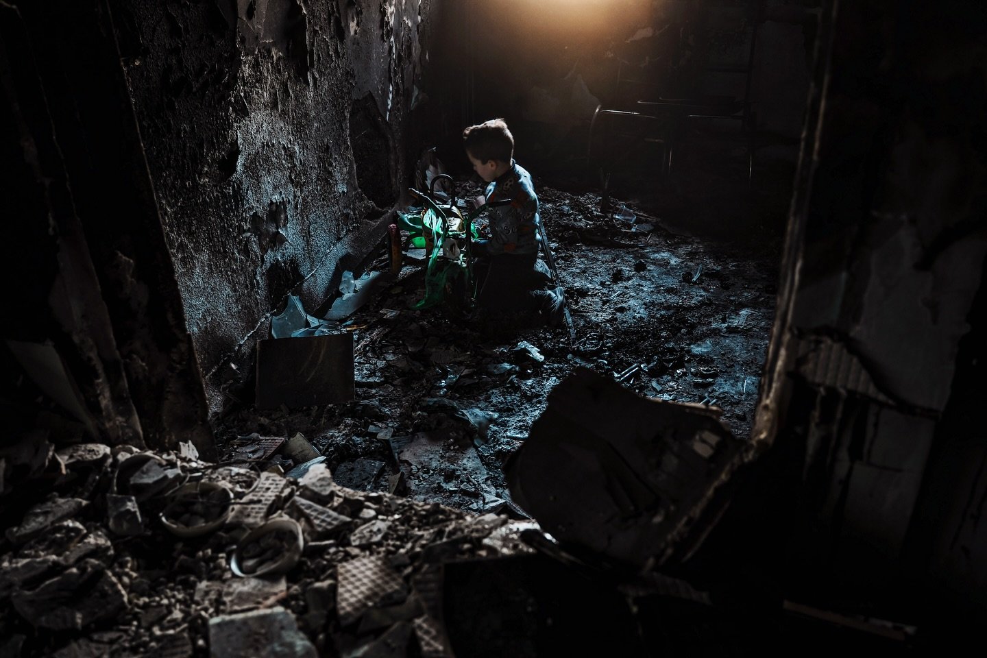 Life and consequences in Jenin: A child saving a melted toy from an incinerated home. Smoke gets in the eyes. A communal sense of grief. a vigilant watch. Death from above. Burying the slain. Losing basic infrastructure. Shockwaves. Hiding from the a