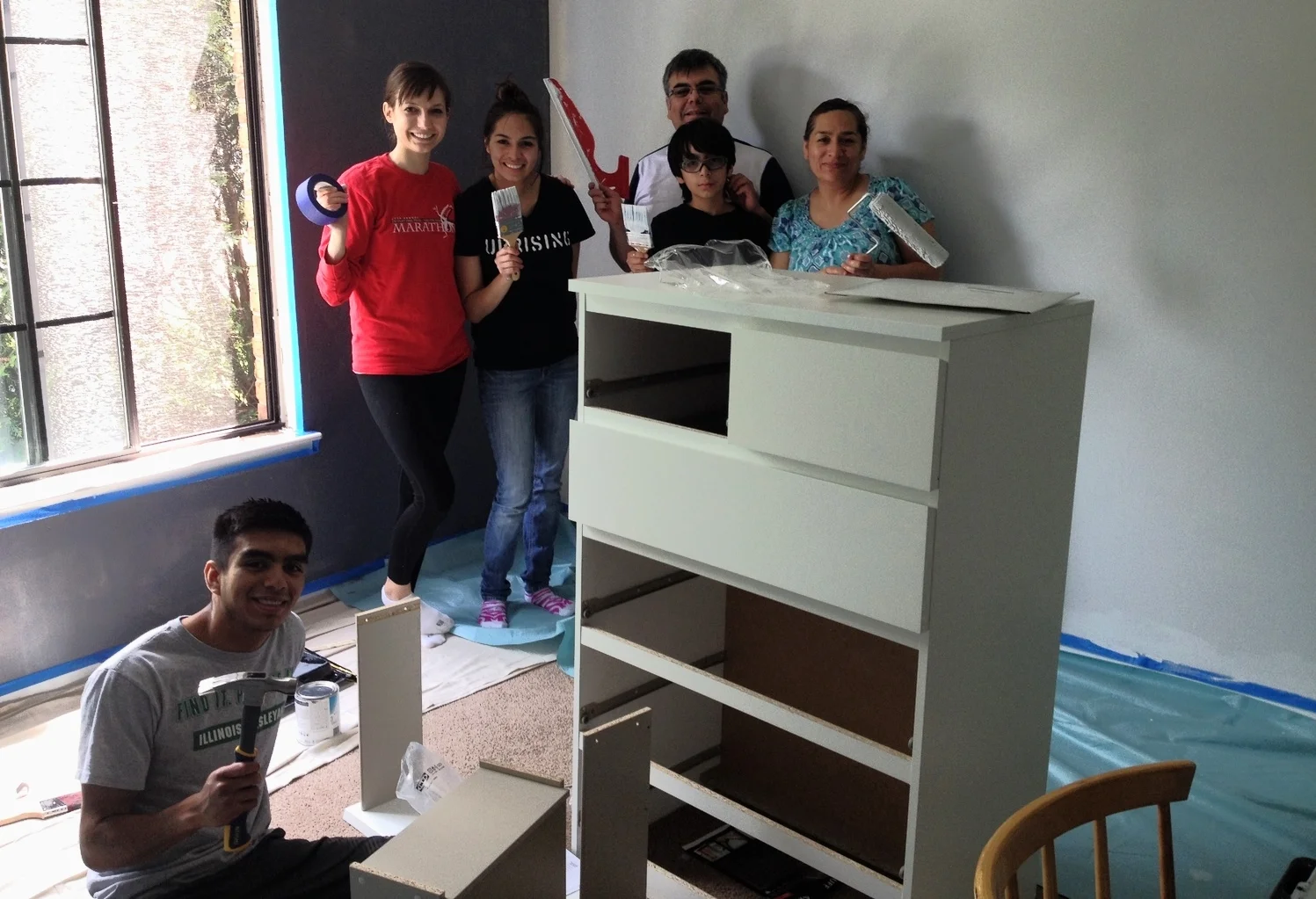 Photo break with the blue wall primed and the grey walls after one coat of paint.