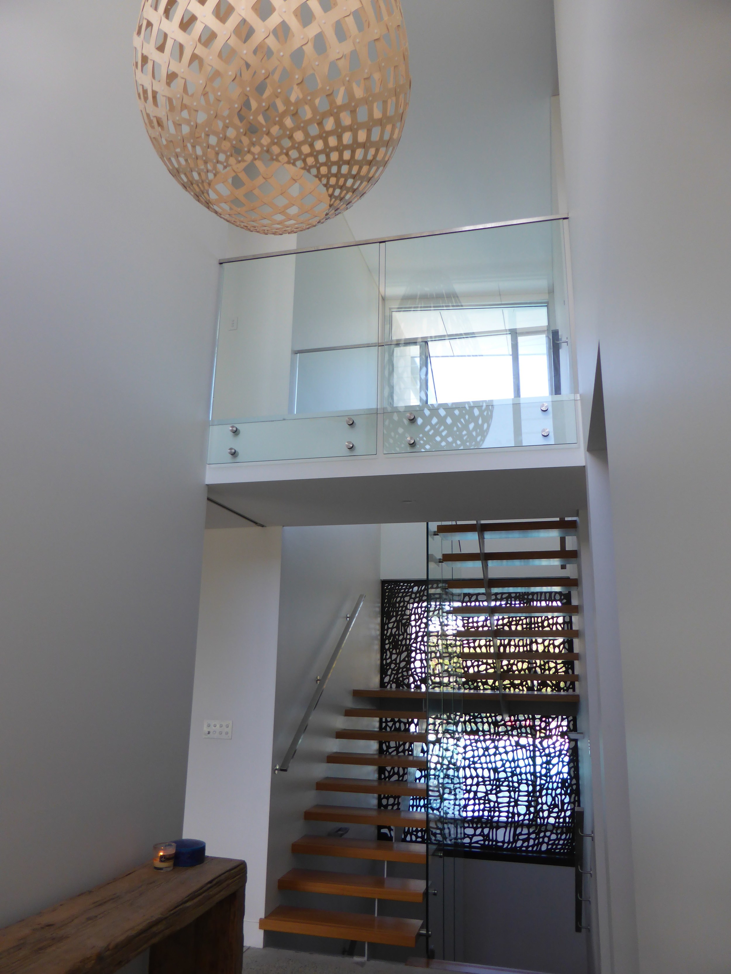 sha designed the open tread stair to provide view lines out to the pool. The metal screen was later added by the client.