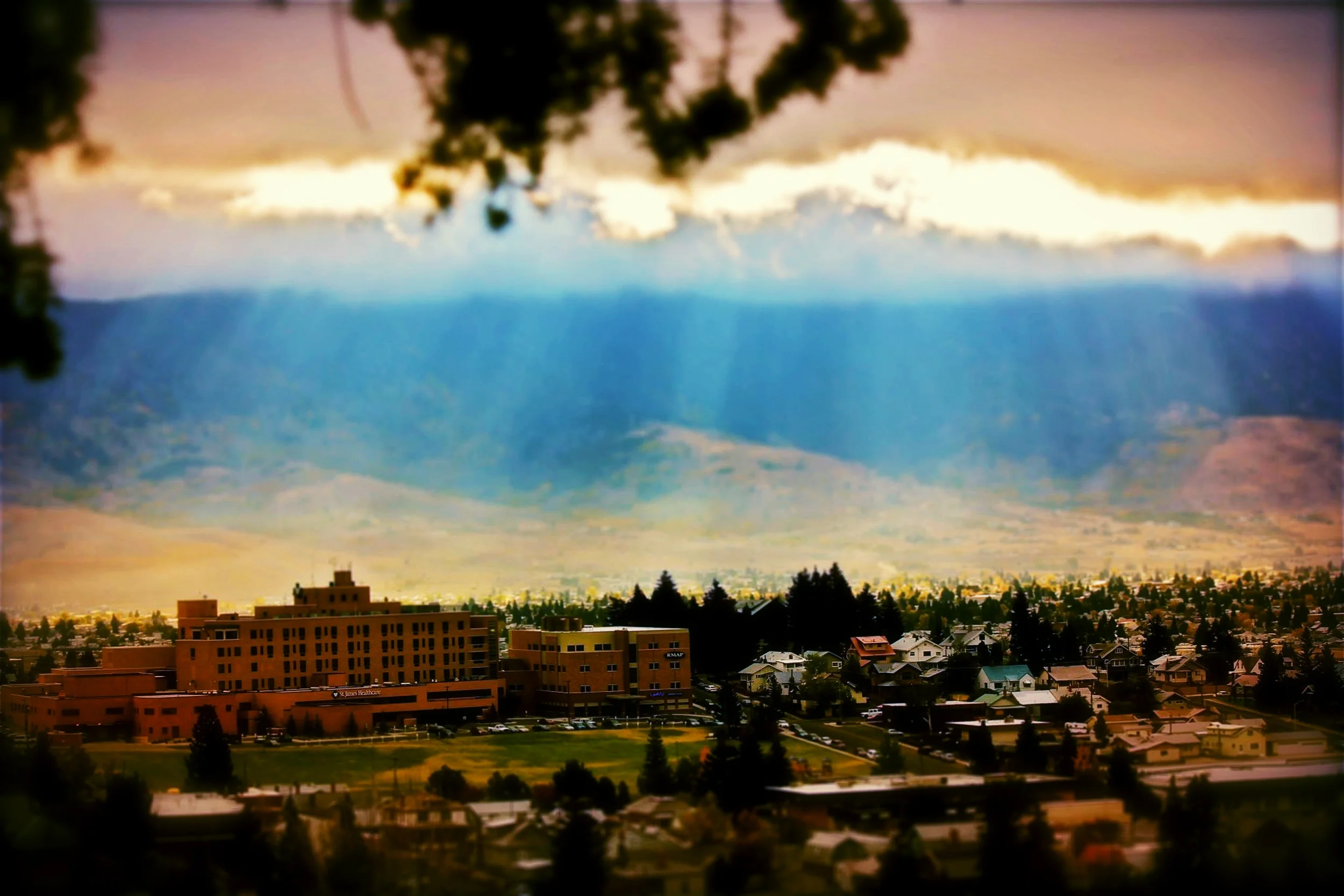 Sun rays filter into the Summit Valley, St. James Healthcare in the foreground (photo: Chad Okrusch)