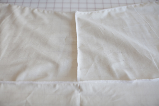 Vertical stitching: The two front pieces serged together. Horizontal stitching: The fronts serged to the back piece lining up the stitching with the center back.