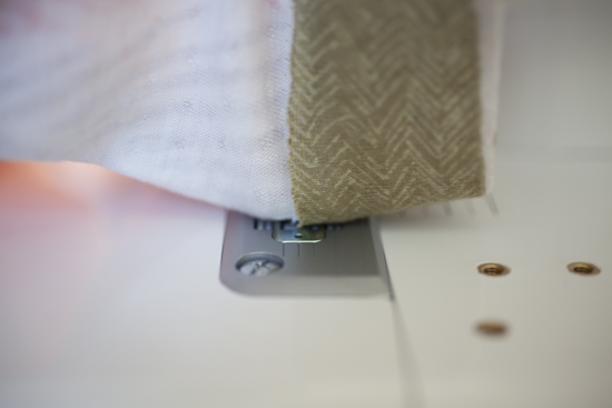 Raw hem lined up with the middle line on the throat plate.