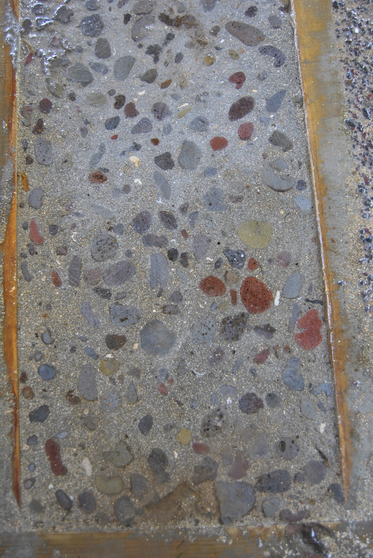 Our first peak at the rough cut concrete floors. I think these will look great when they are polished and sealed. Muriel really likes the reds and blues from the local lava rock. 