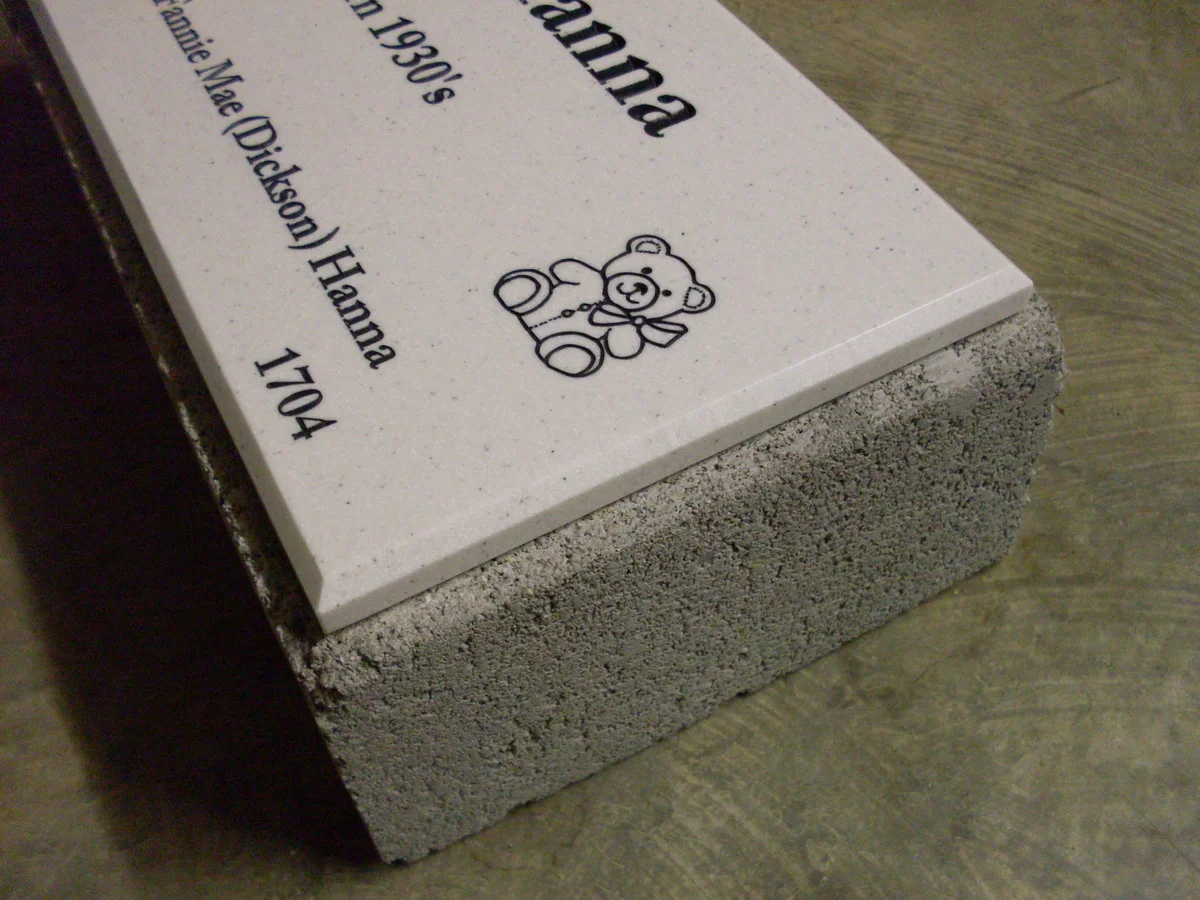 Edge view of a Corian face mounted to the solid cinder block substrate
