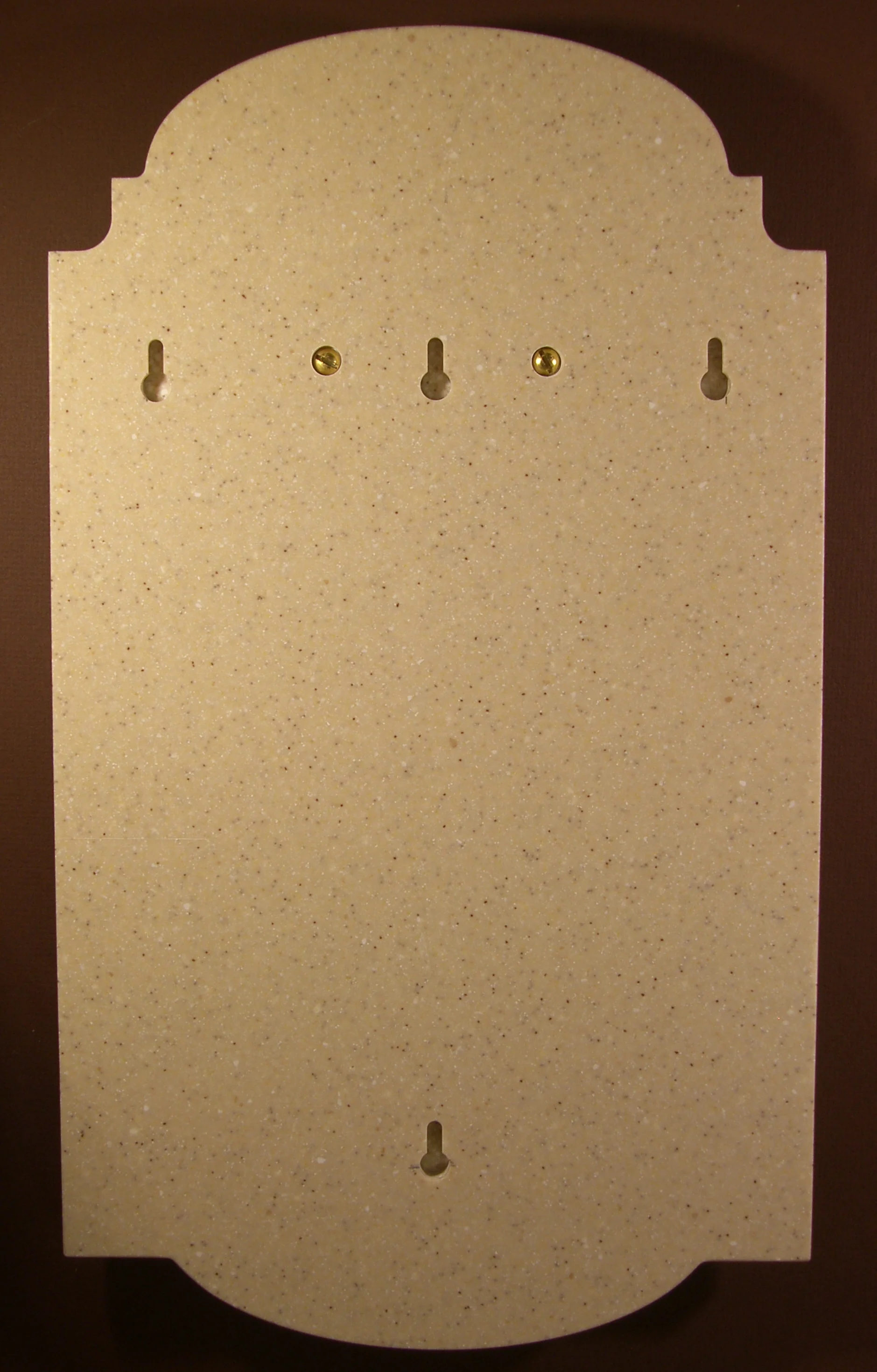 Hanging arrangement on Corian plaque. Can use one screw, or for more stability, two screws horizontal or two screws vertical (preferred)